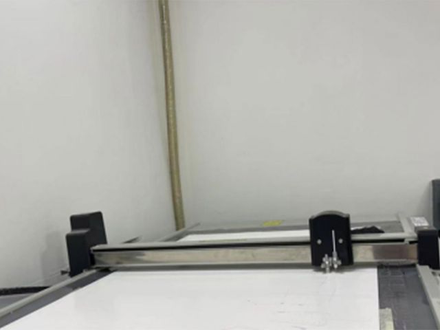A flatbed pattern cutting machine with an empty cutting table.