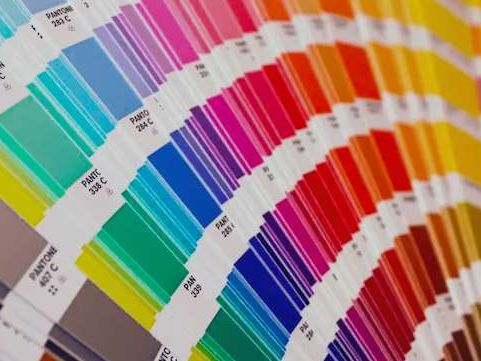 Fanned color swatch cards in a wide range of colors.
